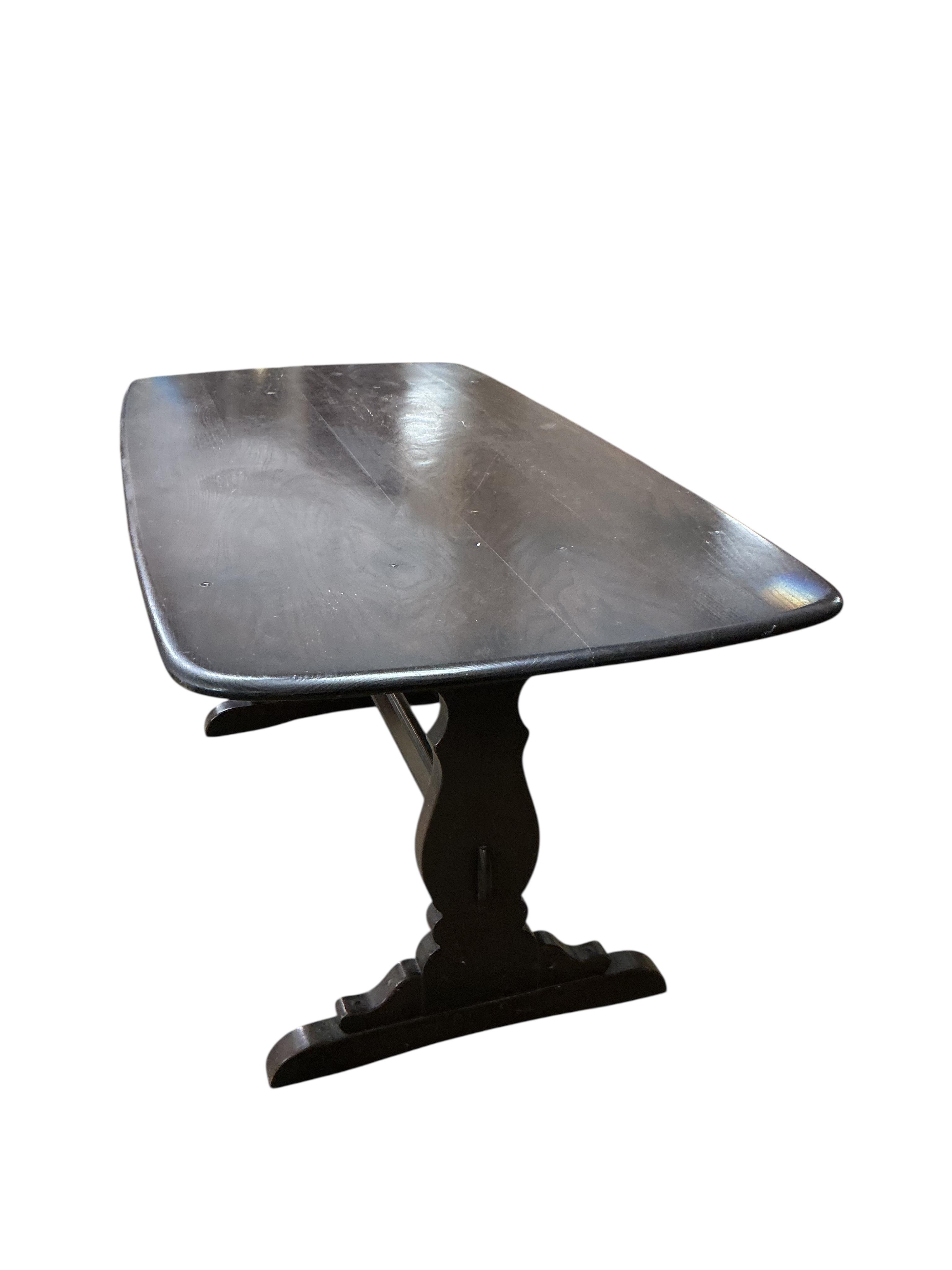 An Ercol dark elm rectangular dining table, width 150cm, depth 77cm, height 72cm and four Ercol chairs